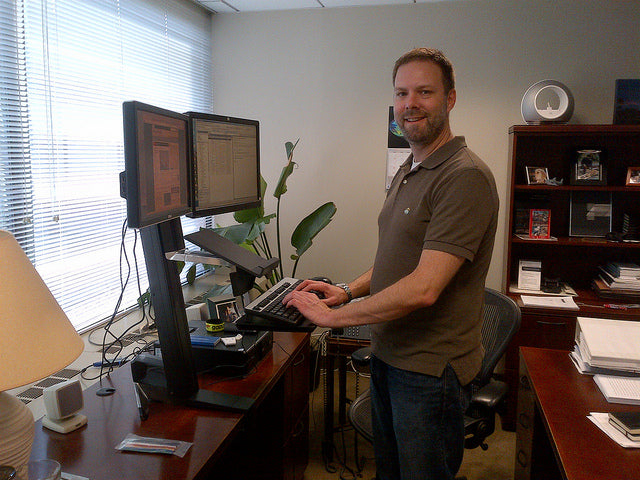 man standing at work station