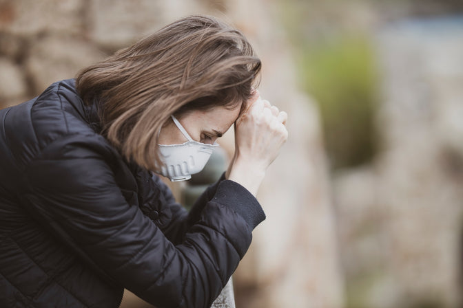 woman wearing mask and under stress