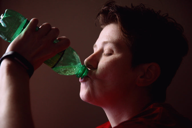 person consuming sugary drink