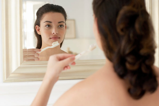 woman brushing teeth remove plaque tartar