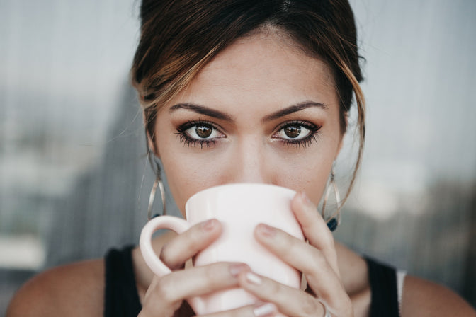 woman drinking cup of coffee