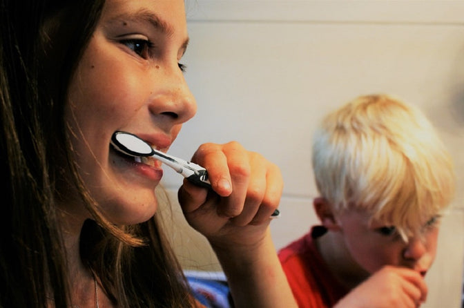 woman child brushing teeth toothbrush safety tips during COVID-19