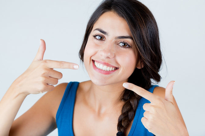 girl with pretty smile using toothpaste tablets