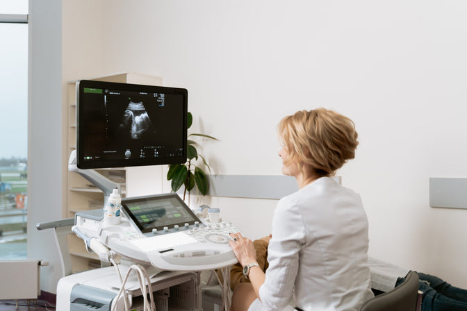 doctor looking at ultrasound machine