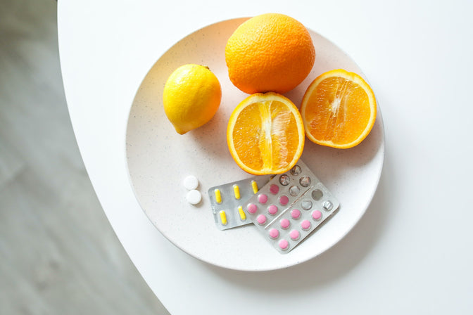 plate full of vitamins lemons and oranges