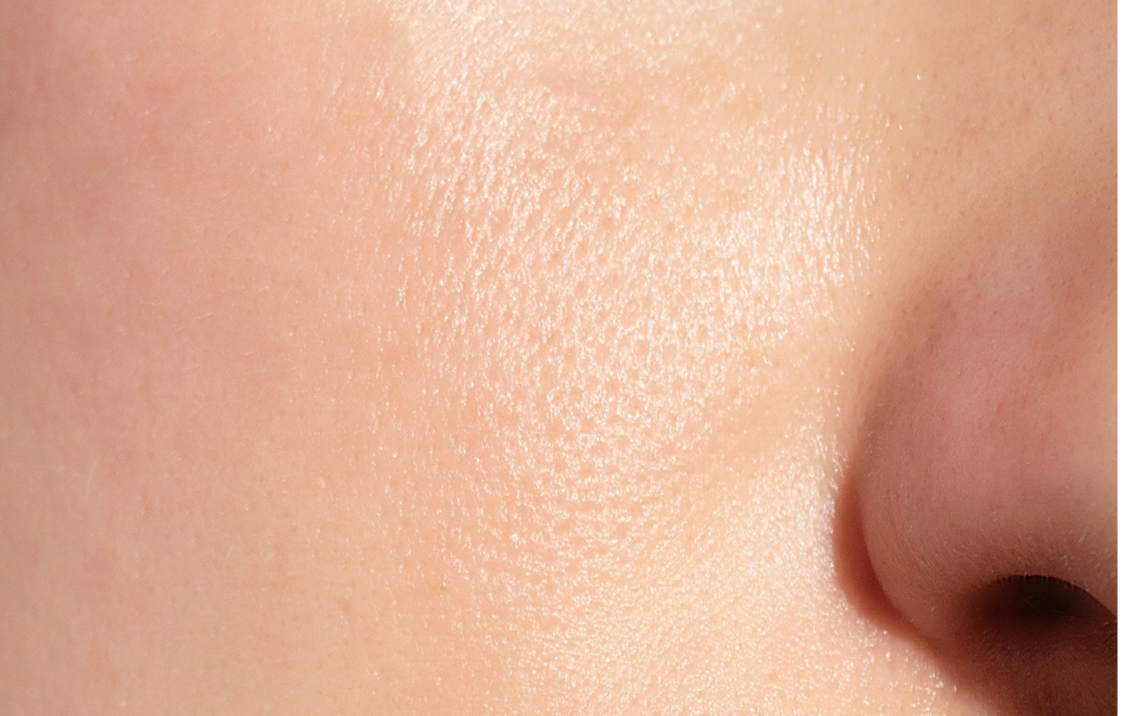 Close-up of a person's nose with smooth skin texture